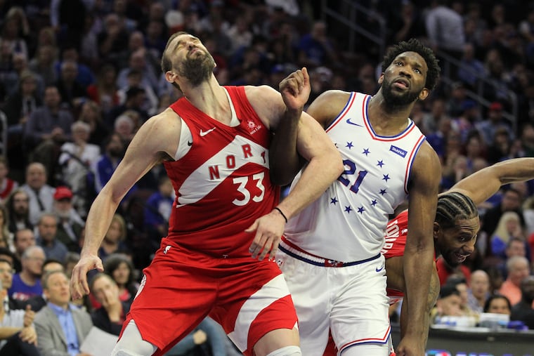 Joel Embiid, right, of the Sixers got called for a flagrant 1 foul for giving Marc Gasol of the Raptors a shot to the face during the 4th quarter of their NBA Eastern Conference Semifinal Playoff Game at the Wells Fargo Center on May 9, 2019.