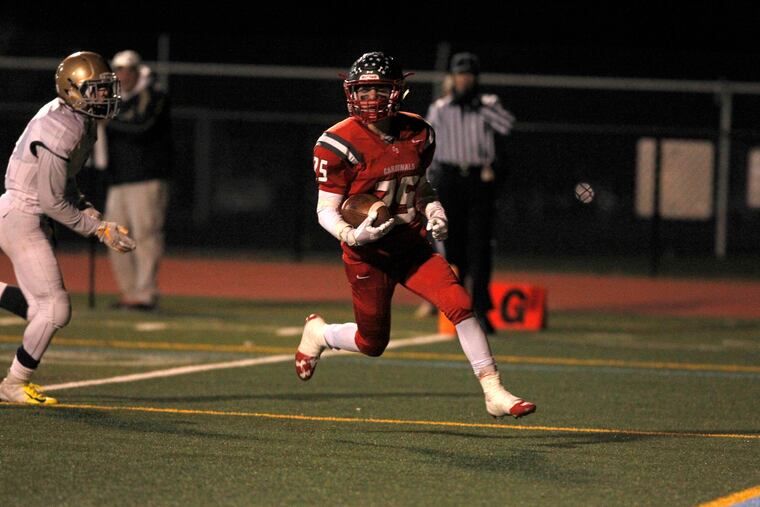 Upper Dublin's Lucas Roselli (25) scores as West Chester Rustin's Collin Hurley looks on.