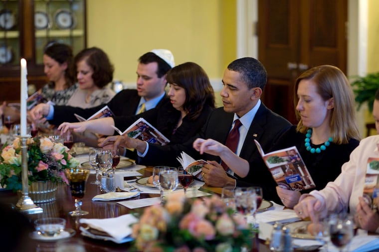 In this image released by the White House, President Barack Obama and the first family mark the beginning of the Jewish holiday Passover with a Seder with friends and staff in the Old Family Dining Room of the White House in Washington, on Monday, March 29, 2010.