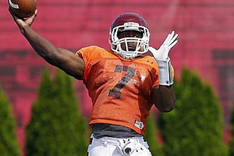 Quarterback Kevin Newsome throws a pass during practice. (David Maialetti/Staff Photographer)