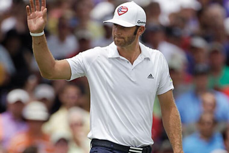 Dustin Johnson waves to the crowd as he leaves the 18th green during the final round of the St. Jude Classic. (Mark Humphrey/AP)