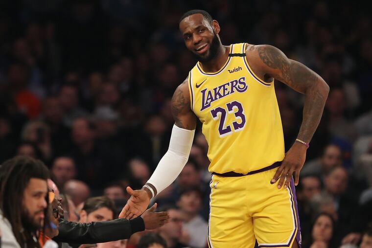 LeBron James (23) smiling as he talks to director Spike Lee during the first quarter against the Knicks on Wednesday.