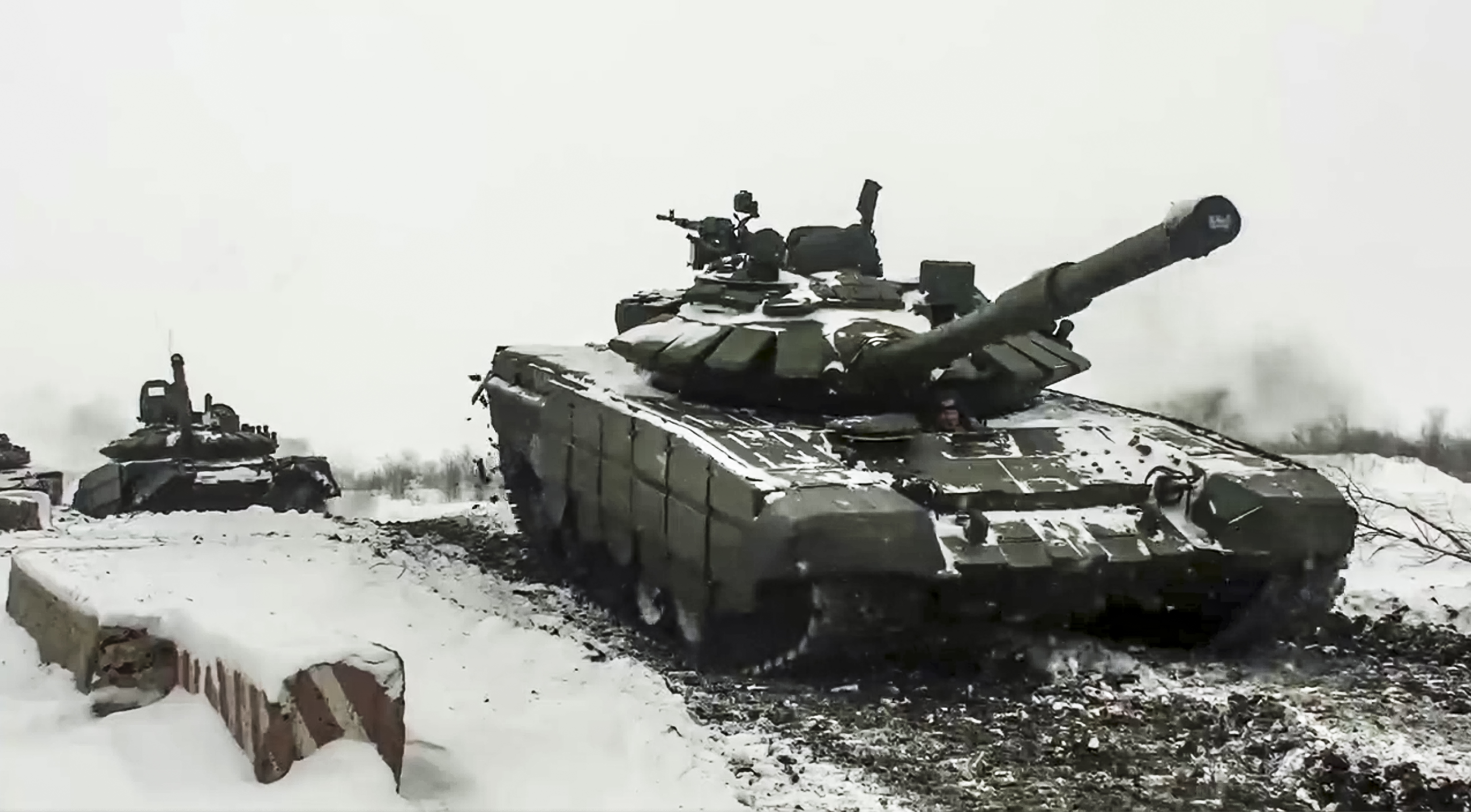 In this photo taken from video provided by the Russian Defense Ministry Press Service on Wednesday, a Russian tank roll during a military exercising at a training ground in the Rostov region of Russia.