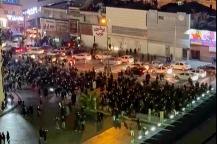 In this frame grab from video taken by an individual not employed by The Associated Press and obtained by the AP outside Iran shows people blocking an intersection during a protest in Tehran, Iran on Thursday.