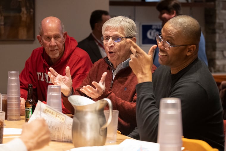 At a reunion of Philadelphia Spirit players and staffers, Bill Lange (center), father of St. Joseph's Coach Billy Lange, is involved in conversation with Emanual Davis (right).