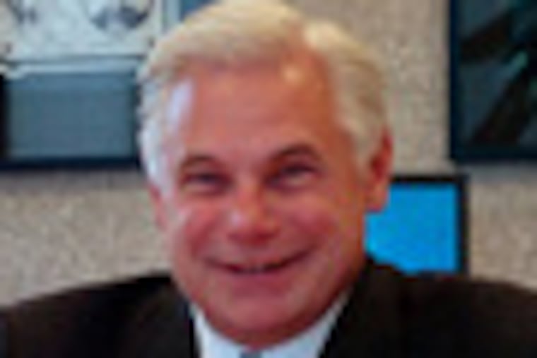 Michael Kalogris, CEO of SunCom Wireless, in his office at SunCom headquarters in Berwyn. (File photo by Sarah J. Glover / Inquirer)