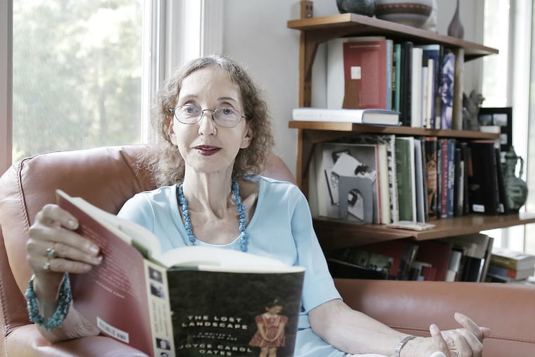 Joyce Carol Oates at home, with a newly arrived copy of her new collection of essays titled "The Lost Landscape." Photo: Elizabeth Roberston/Inquirer Staff