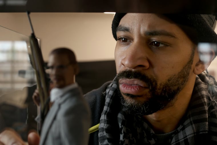 Artist Acori Honzo adjusts a Malcolm X figurine in a case at his studio on Cherry Street Pier in Philadelphia, Pa. on January 21, 2021. Honzo sculpts a thoughtful variety of famous Black figures.