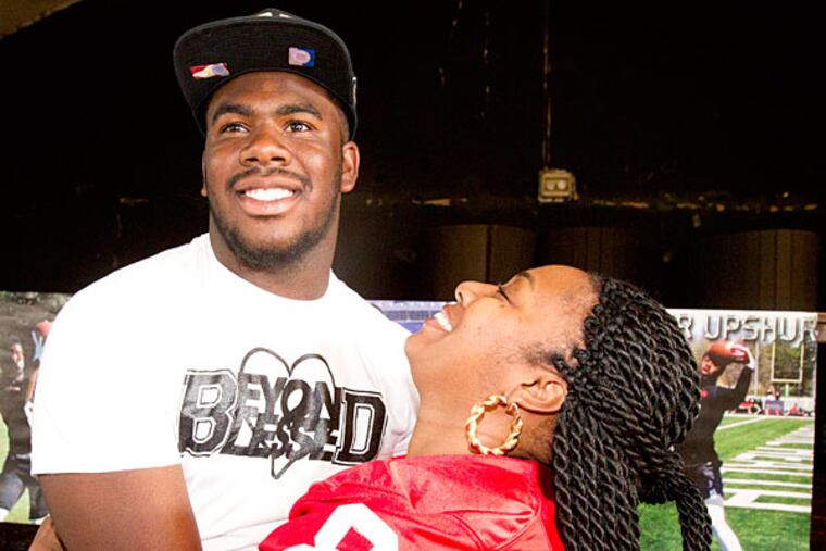 Imhotep Charter tight end Naseir Upshur is hugged by his mother Nickeya James after Naseir announced he will attend Florida State.