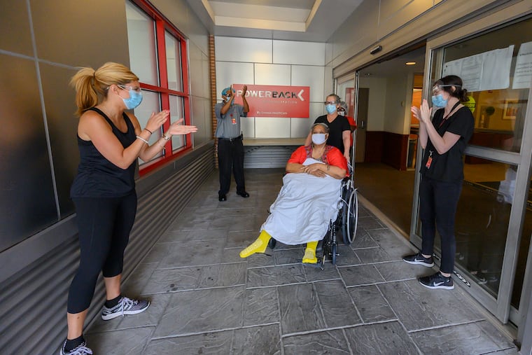 Veronica Alexander, 61, is given the traditional clap out as she is wheeled on Aug. 8 from Powerback Rehabilitation after spending a month in the hospital and 30 days at the rehab facility recovering from COVID-19.