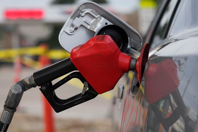 A motorist fills up the tank on a sedan in Saratoga, Wyo.