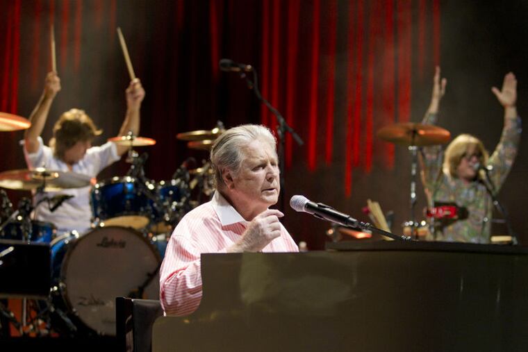 Brian Wilson, longtime leader of the Beach Boys, shown with drummer Mike D'Amico (left) and percussionist Nelson Bragg, played the Mann Center for the Performing Arts on June 29, 2015.