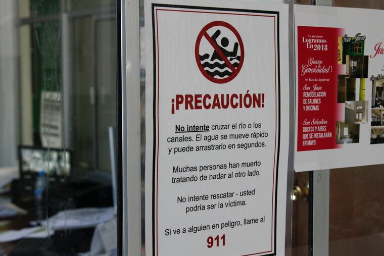 This June 13, 2019, photo shows a sign that reads "Many people have died trying to swim to the other side," posted in a church sheltering Central American migrants in Ciudad Juarez, Mexico.