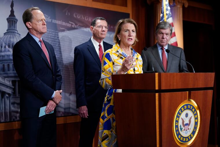 Sen. Shelley Moore Capito speaks at the Capitol in Washington on Thursday as (from left) Sen. Pat Toomey, R-Pa.; Sen. Barrasso, R-Wy.; and Sen. Roy Blunt, R-Mo., look on.