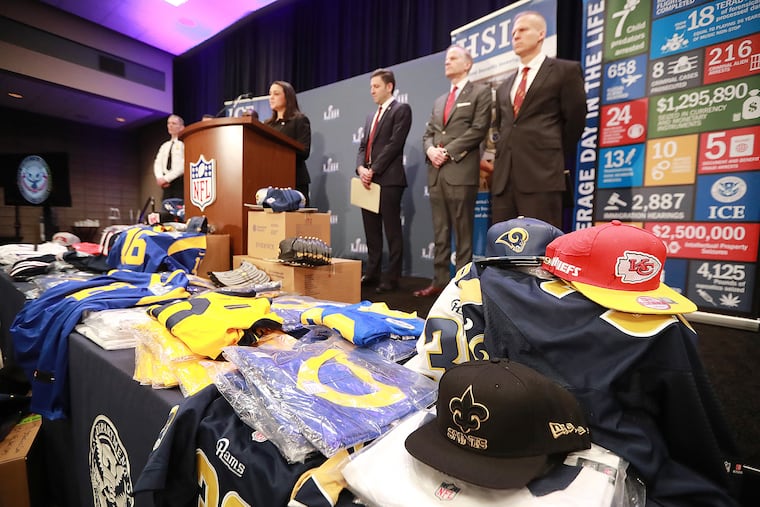 Fake merchandise displayed on a table as the National Football League and law enforcement agencies announced seizures of fake merchandise and tickets in January 2019, at a press conference in Atlanta. (Curtis Compton/Atlanta Journal-Constitution/TNS)