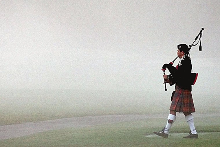 Steve Agan, with the Hamilton Pipe Band, plays "Going Home" as he walks down the first fairway to start a memorial service for Payne Stewart on Oct. 28, 1999. (David J. Phillip/AP file photo)