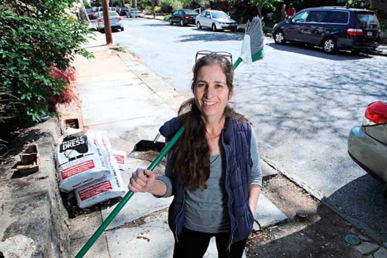 Celia Pretter stands on her street in Mt Airy where she did her best to clean up the whole block one day. ( Michael Bryant / Staff Photographer )