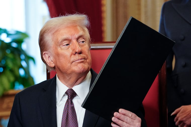 President Donald Trump, center, takes part in a signing ceremony in the President's Room after the 60th Presidential Inauguration, Monday, Jan. 20, 2025, at the U.S. Capitol in Washington.