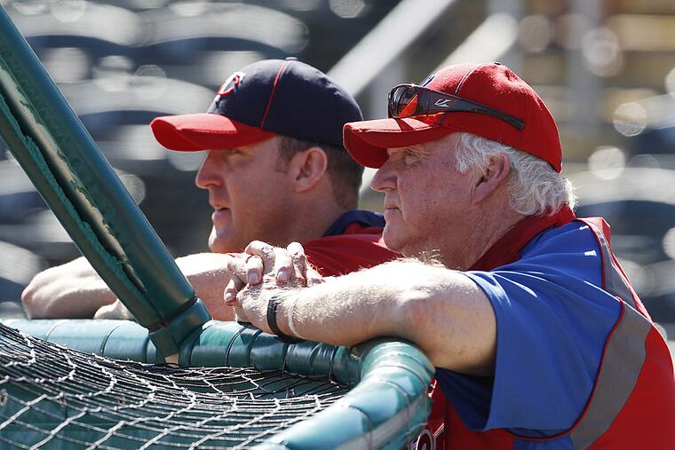 Charlie Manuel, right, watches batting practice alongside Jim Thome.
