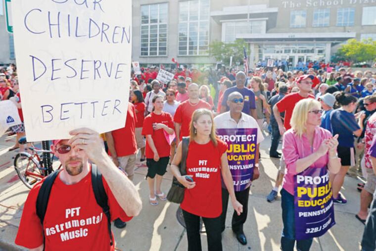 Demonstrators protest outside the school district headquarters, Thursday, May 30, 2013, in Philadelphia. (AP Photo/Matt Rourke)