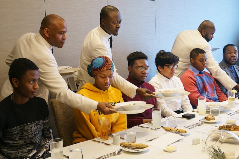 High school-age culinary students (Left to Right) Nocqui Howard, Naomi Clement, Isiah Dorvil, Jose Pedraza, Malcolm Waugh, and Keith Pretlow, a Culinary Arts Teacher, and Teyanna Trice, study business lunch etiquette, at the Four Seasons in the Comcast Technology Center. The event was part of a program offered by the Pennsylvania Restaurant & Lodging Association.