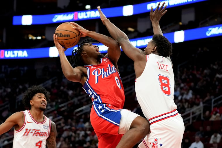 Tyrese Maxey drives to the basket as Houston Rockets forward Jae'Sean Tate defends.