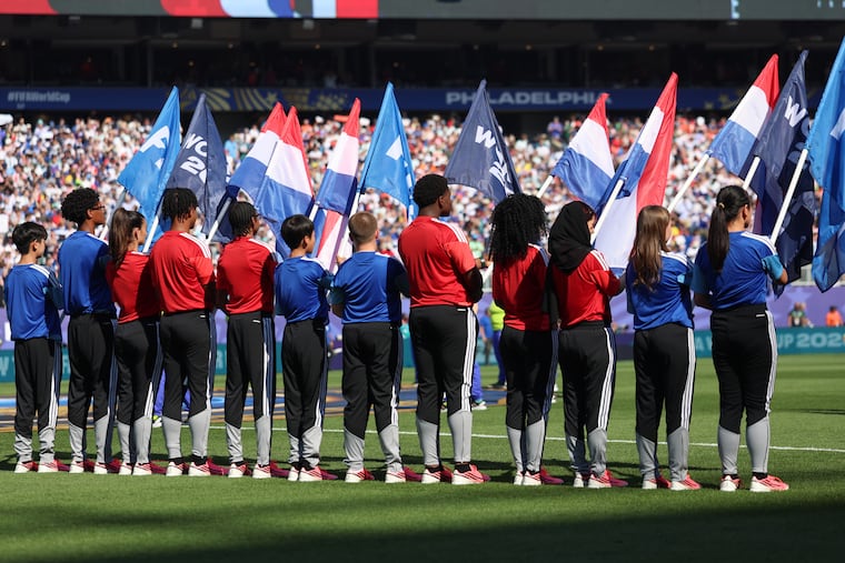 Isaac Oquendo (fourth from left) was a flag bearer during France's match against Paraguay in the FIFA World Cup Round of 16 match in Philadelphia on Saturday.