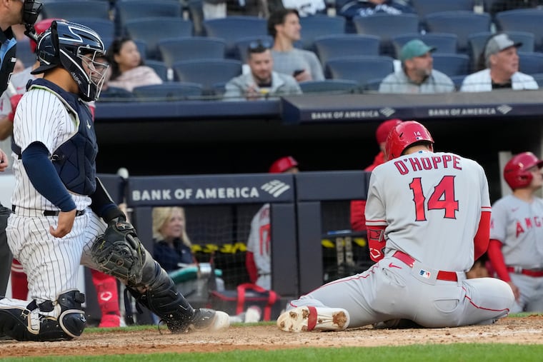 Los Angeles Angels' Logan O'Hoppe falls after hitting a single during the ninth inning.