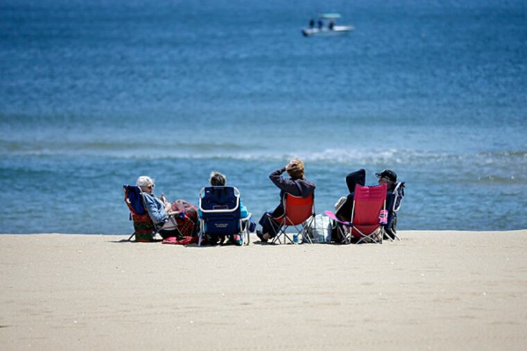 An Assembly committee advanced legislation Thursday that would make New Jersey the first state to ban smoking in all public parks and beaches. Here, people are bundled again the wind as they relax on a Jersey beach on Sunday, May 26, 2013. (AP Photo/Mel Evans/File)