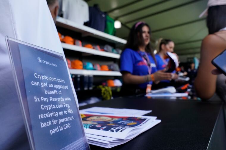 A sign announcing upgrades for cryptocurrency users is shown at a shop at the Formula One Miami Grand Prix auto race at Miami International Autodrome on Sunday in Miami Gardens, Fla.