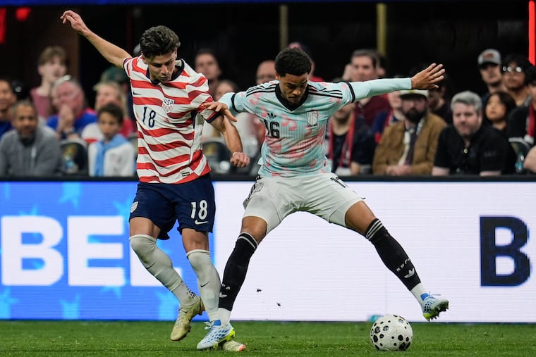 United States' Max Arfsten (left) battles for a loose ball with Belgium's Koni De Winter in Saturday's exhibition meeting between the two teams.
