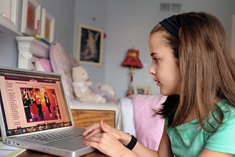 Zero interest in dolls": Kelsey Mauger, 8, of North Wales, plays on her computer. She likes Club Penguin, where penguin avatars travel a virtual world and friends meet to chat online. (Sharon Gekoski-Kimmel / Staff)