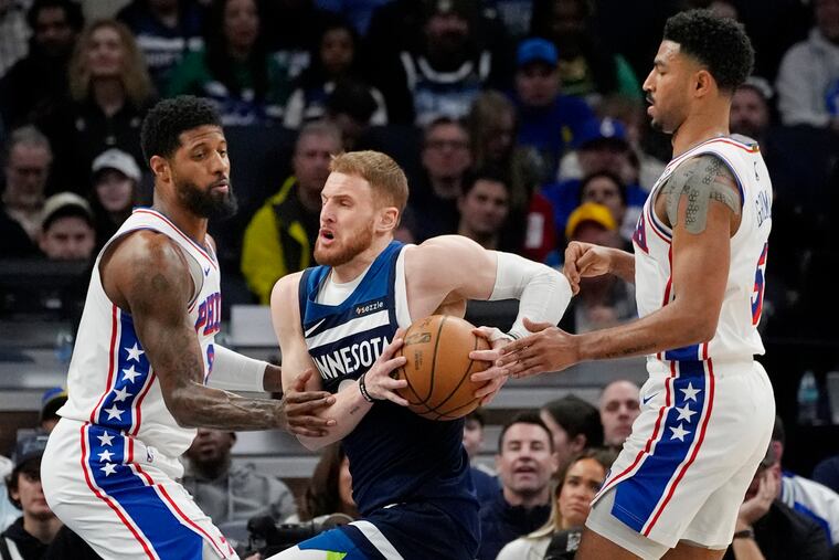 Minnesota Timberwolves guard Donte DiVincenzo drives to the basket between 76ers forward Paul George and guard Quentin Grimes during Tuesday's game.