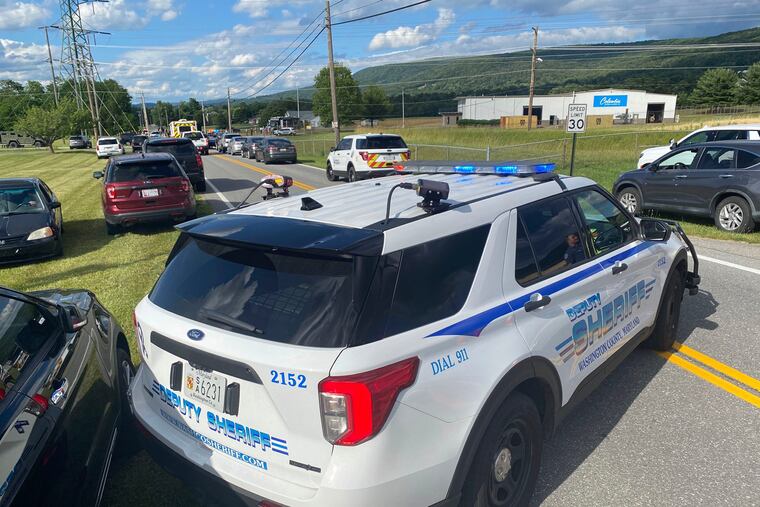 Law enforcement stages near the scene of a shooting at Columbia Machine, Inc., in Smithsburg, Md.