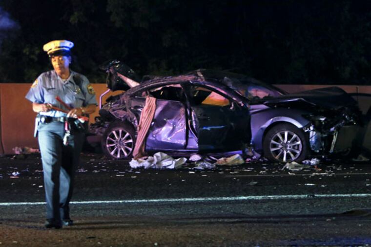 Accident investigators gathered on Woodhaven Road near Thorton Road after a two-car accident. (Joseph Kaczmarek / For the Inquirer and Daily News)