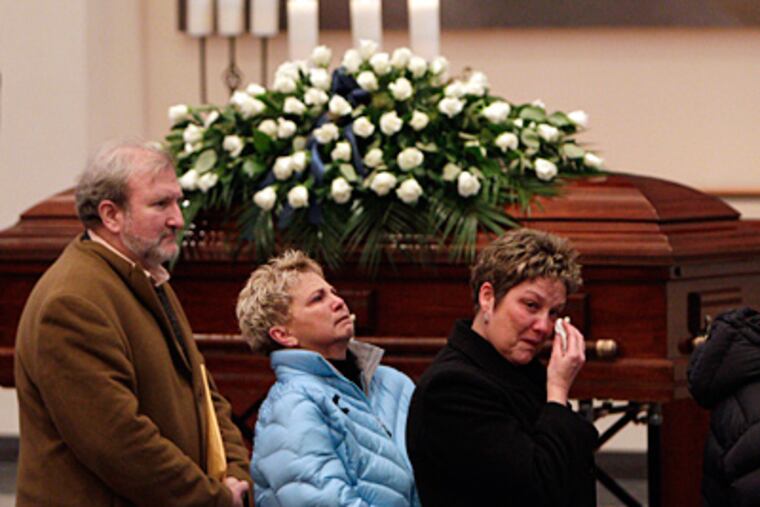 Mourners file past Joe Paterno's casket at the Pasquerilla Spiritual Center, which donations from Paterno and his wife helped build. (David Maialetti/Staff)