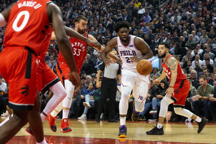 Joel Embiid had a tough time against Marc Gasol (33) and the Raptors on Monday.