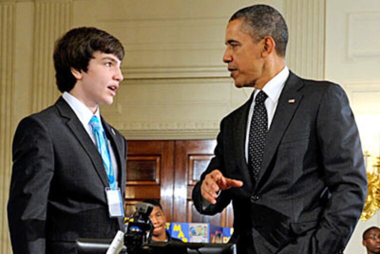 President Obama talks with Benjamin Hylak of West Grove about his interactive robot during the White House Science Fair. The fair celebrates the student winners of a broad range of science, technology, engineering and math competitions from across the country. (Susan Walsh / Associated Press)