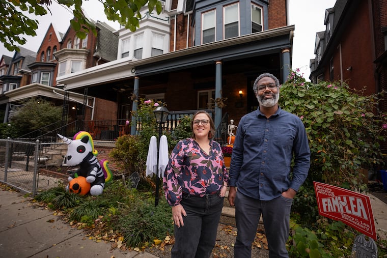 Homeowners Kate Sheppard and Deen Freelon outside their West Philly home.
