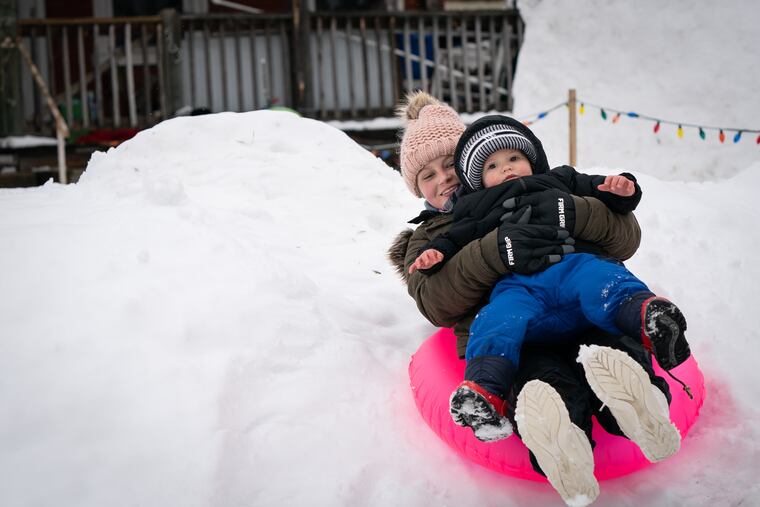 Amanda Guzik, 17, sleds with her cousin Christopher Hennessey, 2, in their front yard, in Norristown, PA, Wednesday February 3, 2021. A large snow storm began in the tri-state area on Sunday afternoon.