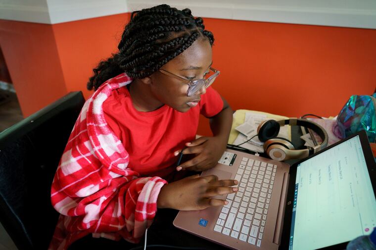A Philadelphia student works on classwork while learning remotely at home in this March photo.
