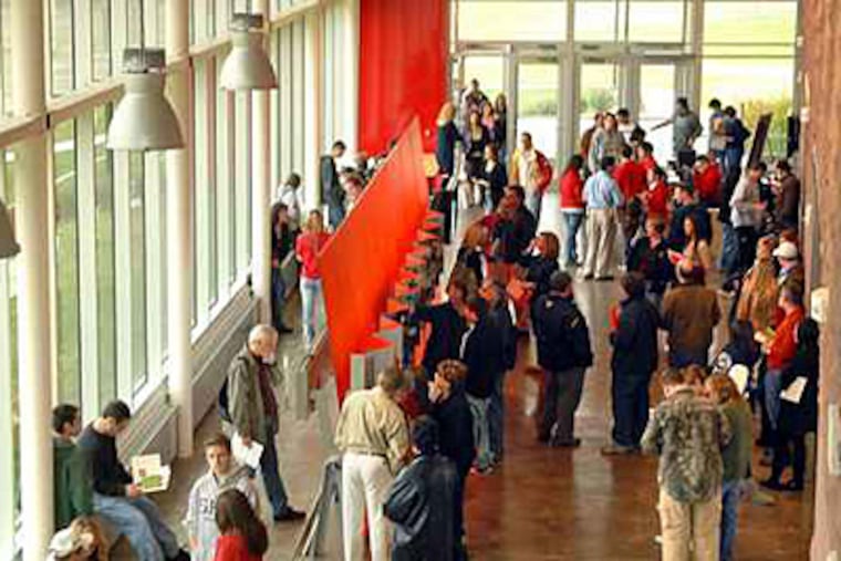 In this file photo from 2009, prospective students and their parents wait for the start of an information session at the new $7 million plus Rutgers University Visitor Center. (Tom Gralish / File)
