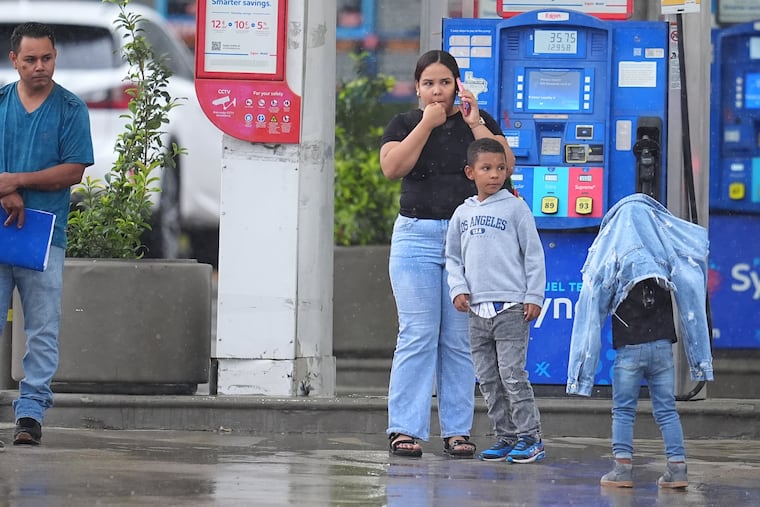 Edwin Cardona (left), who had an appointment at the U.S. Immigration and Customs Enforcement office, stands with his wife, Arianny Sierra, and their sons, after a shooting Wednesday at the Dallas facility.