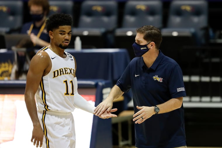 Camren Wynter (left) was named first-team All-CAA after a strong junior season. Coach Zach Spiker is right of him.