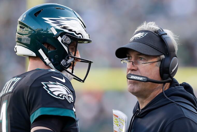 Eagles coach Doug Pederson (right) and quarterback Carson Wentz have a daunting task to make the playoffs.