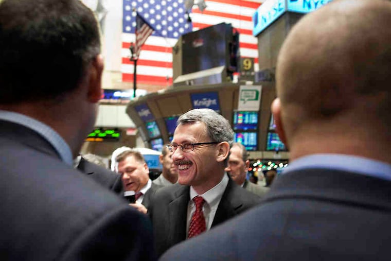 Dan Moloney, president of Motorola Mobility Inc., touring the floor of the New York Stock Exchange after the opening bell Tuesday. Under the company split, Motorola Mobility will target consumers; Motorola Solutions will aim at professionals.