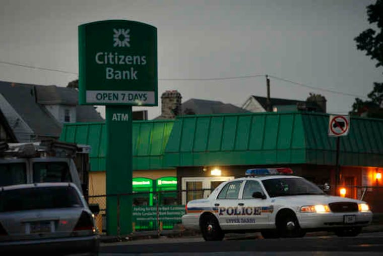 An Upper Darby patrol car blocks traffic during the investigation of the shooting of an officer. Police said they found marijuana, crack, a scale, and a knife in the possession of the suspect.