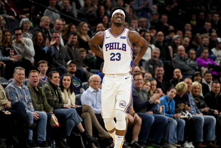Jimmy Butler (23) winces in pain after a first-quarter injury against the Minnesota Timberwolves.