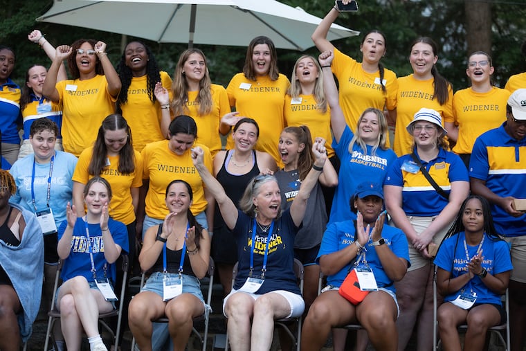 Widener University president Stacey M. Robertson (bottom center) poses for a group shot with students after a dinner on Wednesday, Sept. 6, 2023.