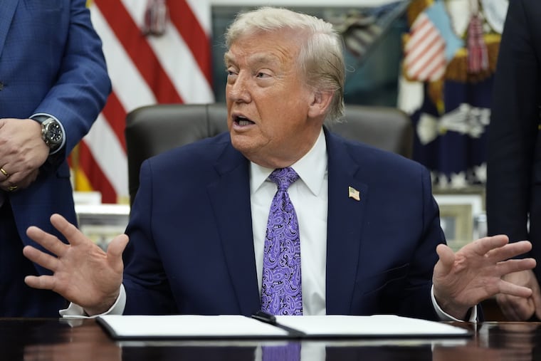 President Donald Trump gestures during Thursday's signing ceremony on an AI initiative in the Oval Office of the White House.
